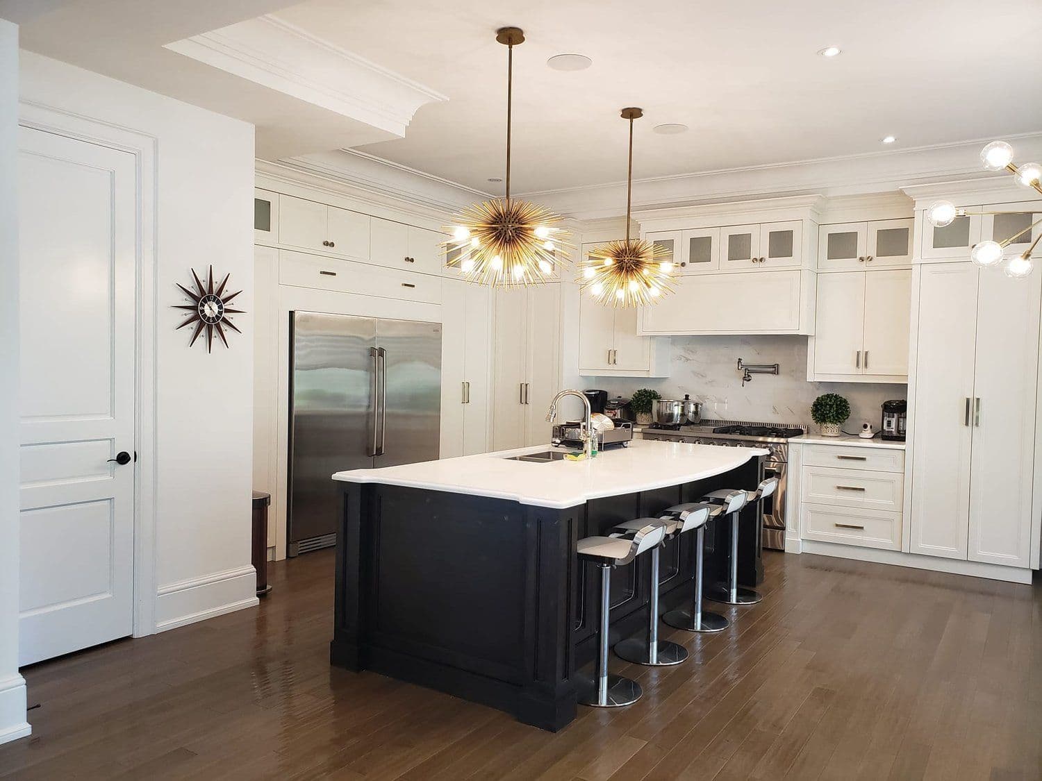 Modern open-concept kitchen with white cabinetry and pendant lighting